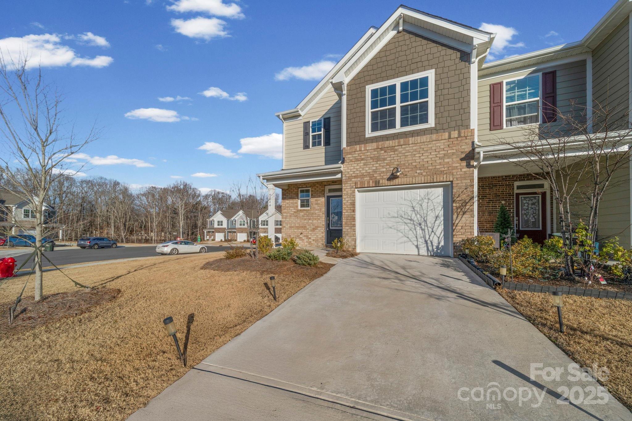 5044 Moss Pine Way Tega Cay, SC 29708 - Photo 35 of 40 a front view of a house with a yard and garage