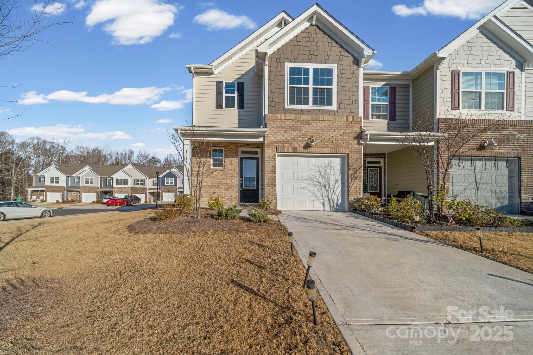 5044 Moss Pine Way Tega Cay, SC 29708 - Photo 36 of 40 a front view of a house with a yard and garage