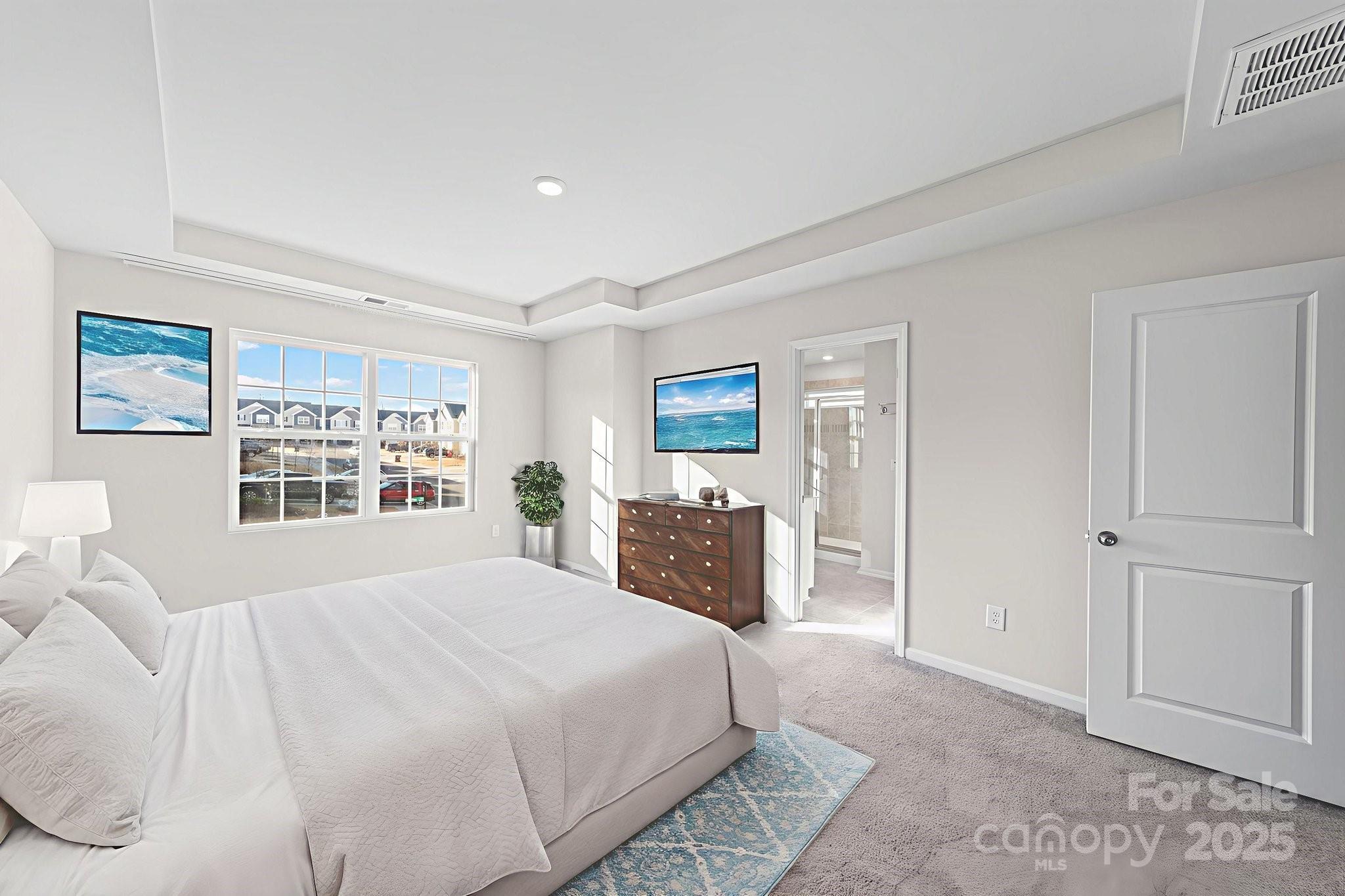 5044 Moss Pine Way Tega Cay, SC 29708 - Photo 5 of 40 a bedroom with a large bed and a window