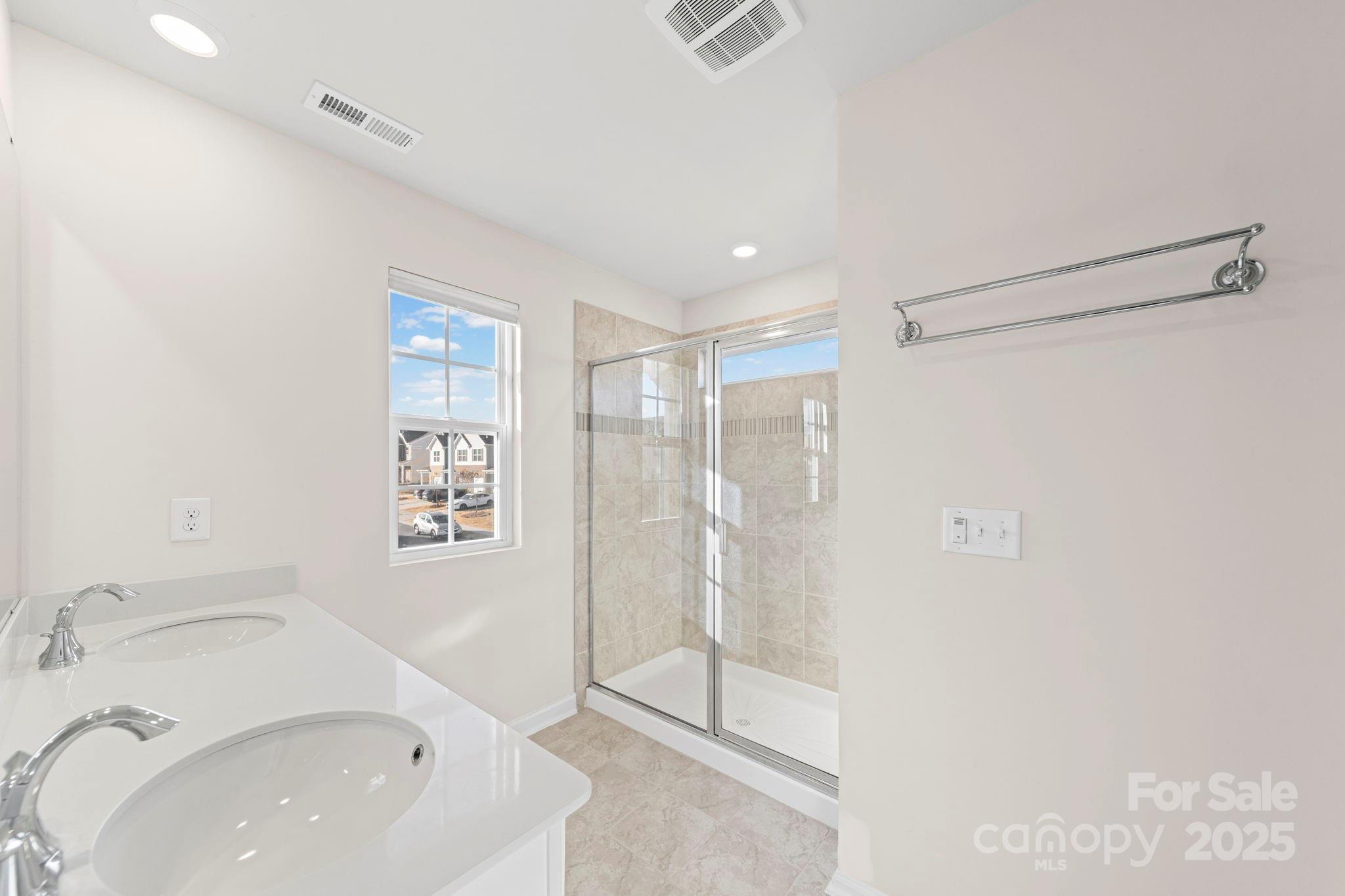 5044 Moss Pine Way Tega Cay, SC 29708 - Photo 7 of 40 a bathroom with a sink and a shower