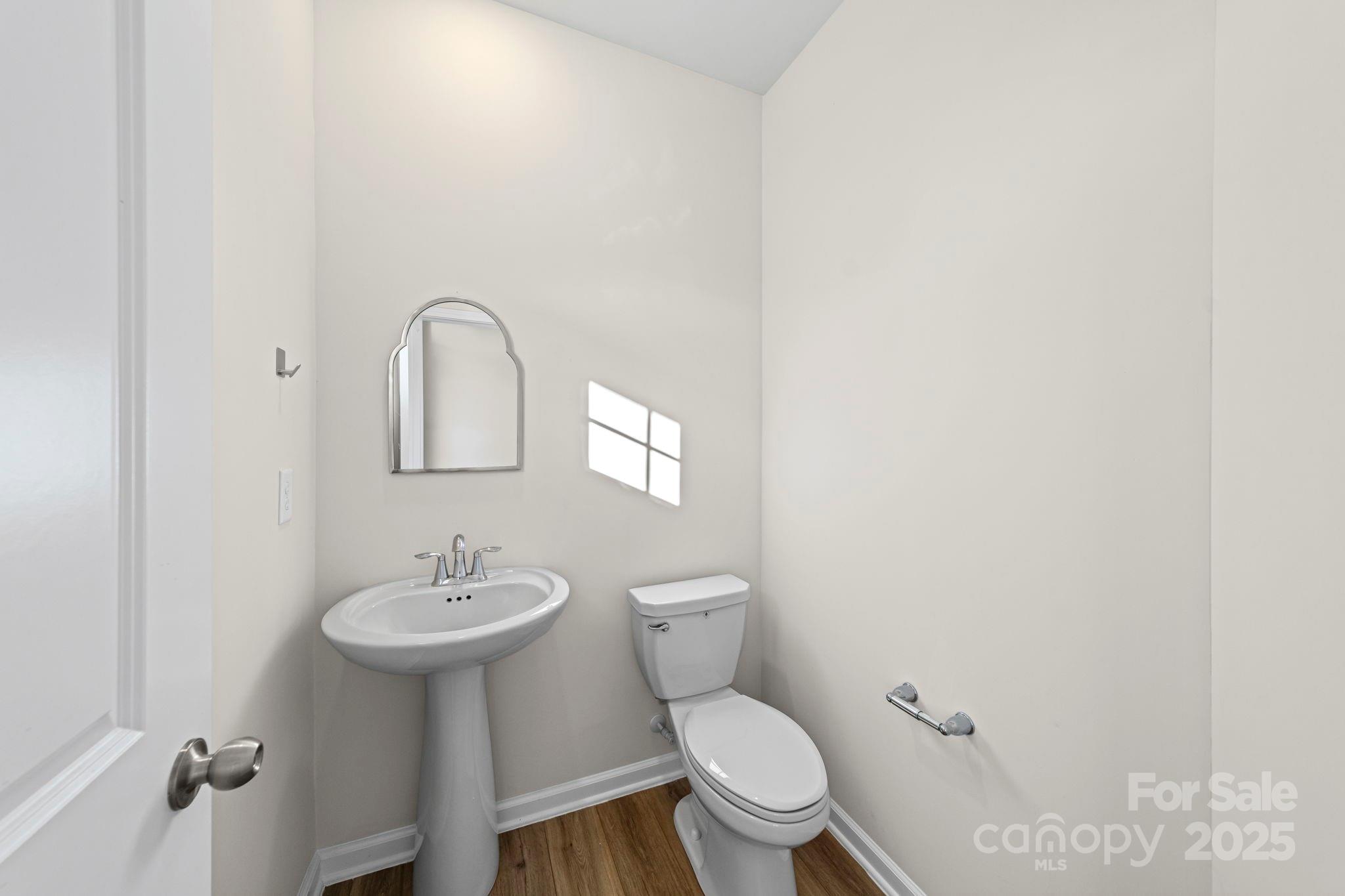 5044 Moss Pine Way Tega Cay, SC 29708 - Photo 10 of 40 a bathroom with a toilet sink vanity and mirror