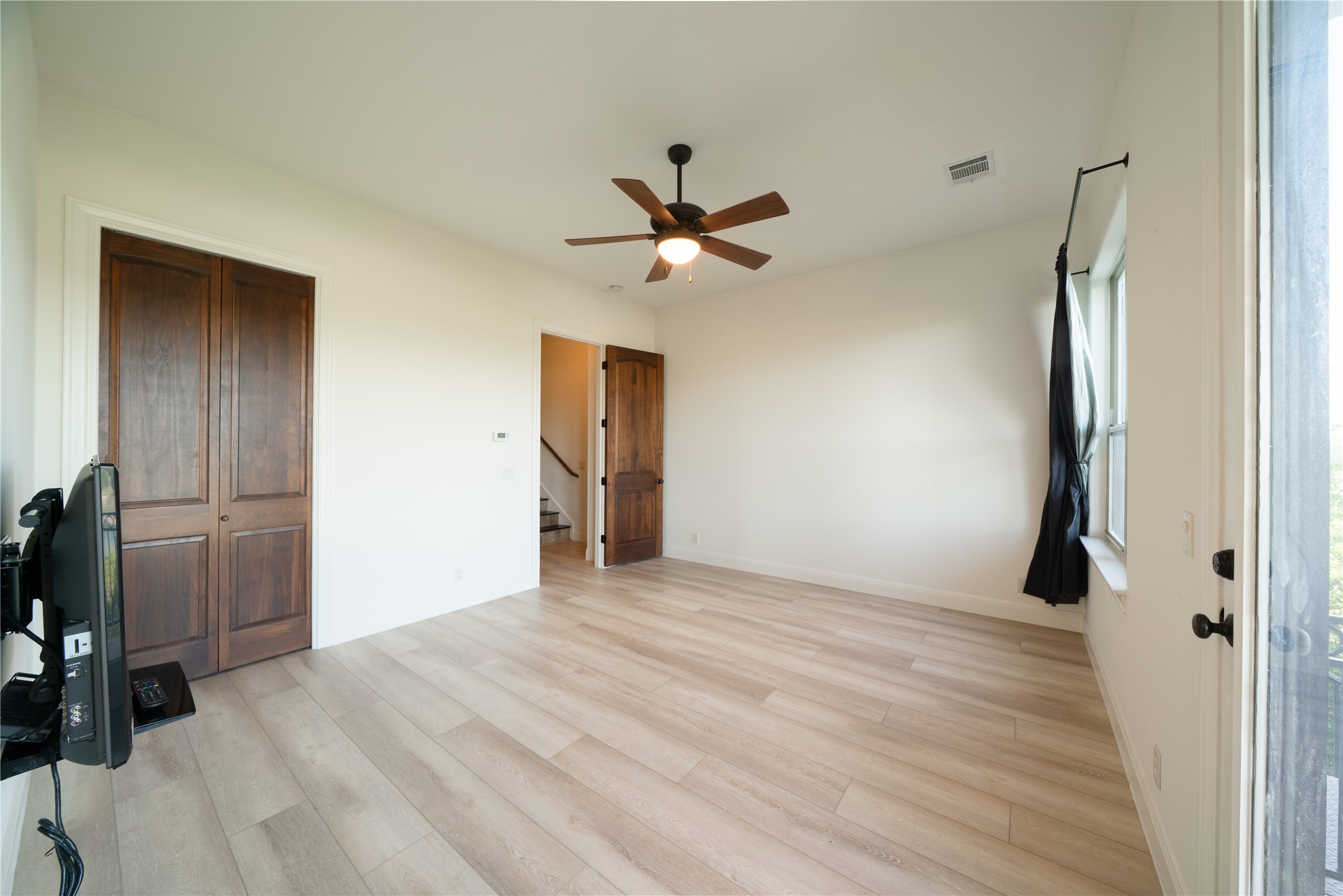 17545 West Reed Park Road, Unit 2 Jonestown, TX 78645 - Photo 29 of 39 wooden floor in an empty room with a window