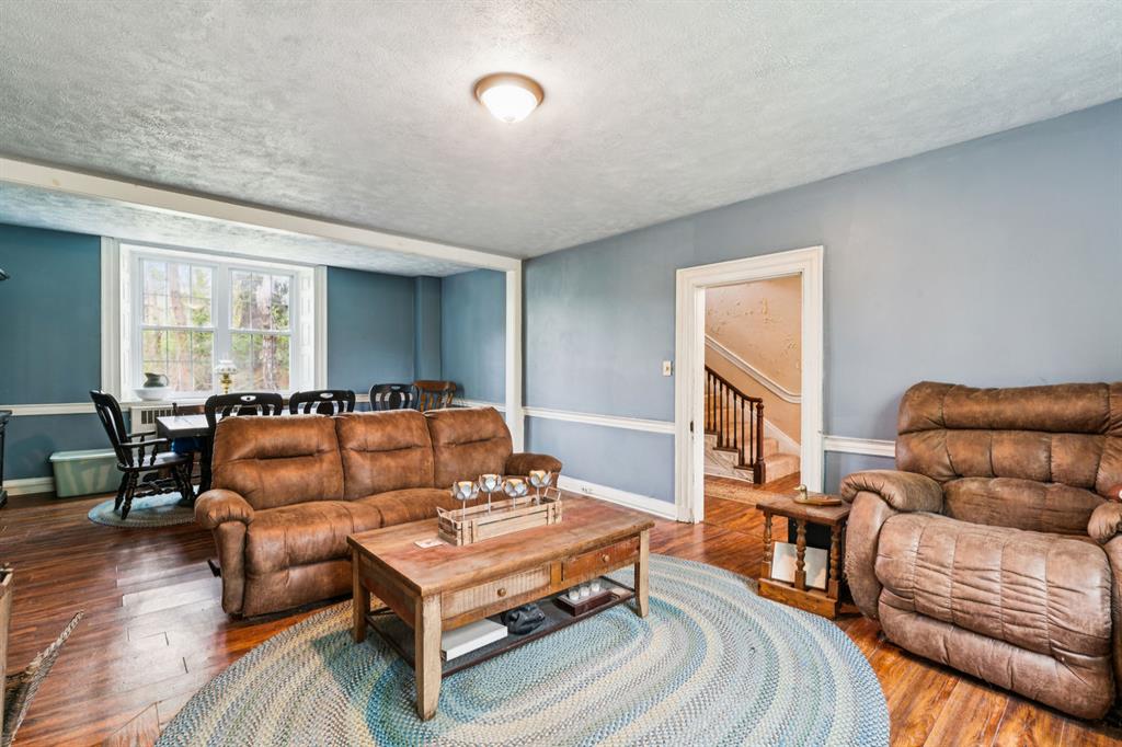 1010 Beaner Hollow Road Beaver, PA 15009 - Photo 21 of 48 a living room with furniture a wooden floor and a large window
