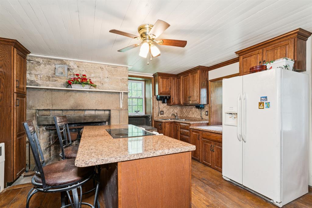 1010 Beaner Hollow Road Beaver, PA 15009 - Photo 26 of 48 a kitchen with stainless steel appliances a stove a refrigerator a dining table and chairs with wooden floor