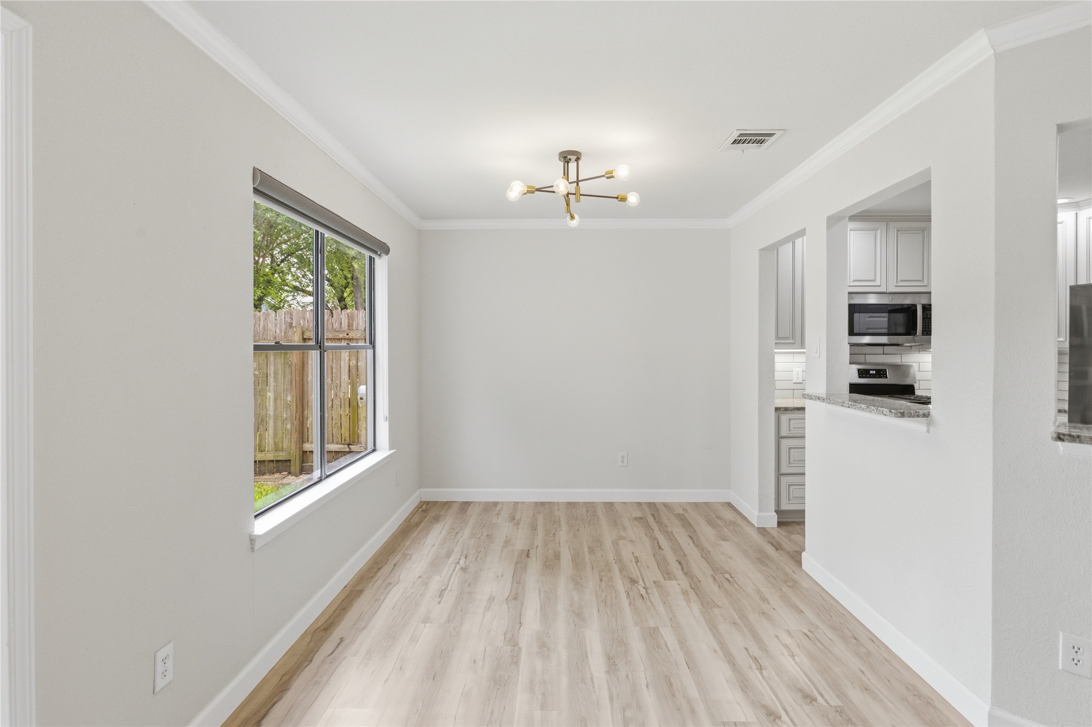 2326 Dowd Lane Austin, TX 78728 - Photo 12 of 30 a view of kitchen with wooden floor electronic appliances and window