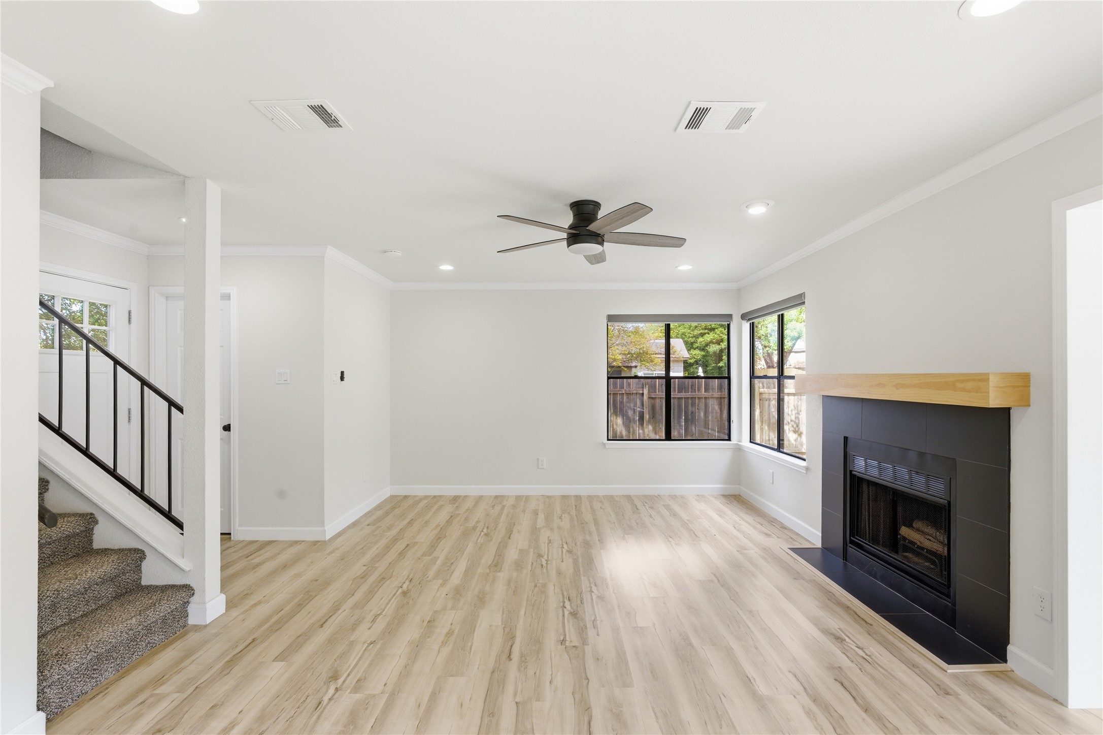 2326 Dowd Lane Austin, TX 78728 - Photo 14 of 30 a view of an empty room with wooden floor fireplace and a window
