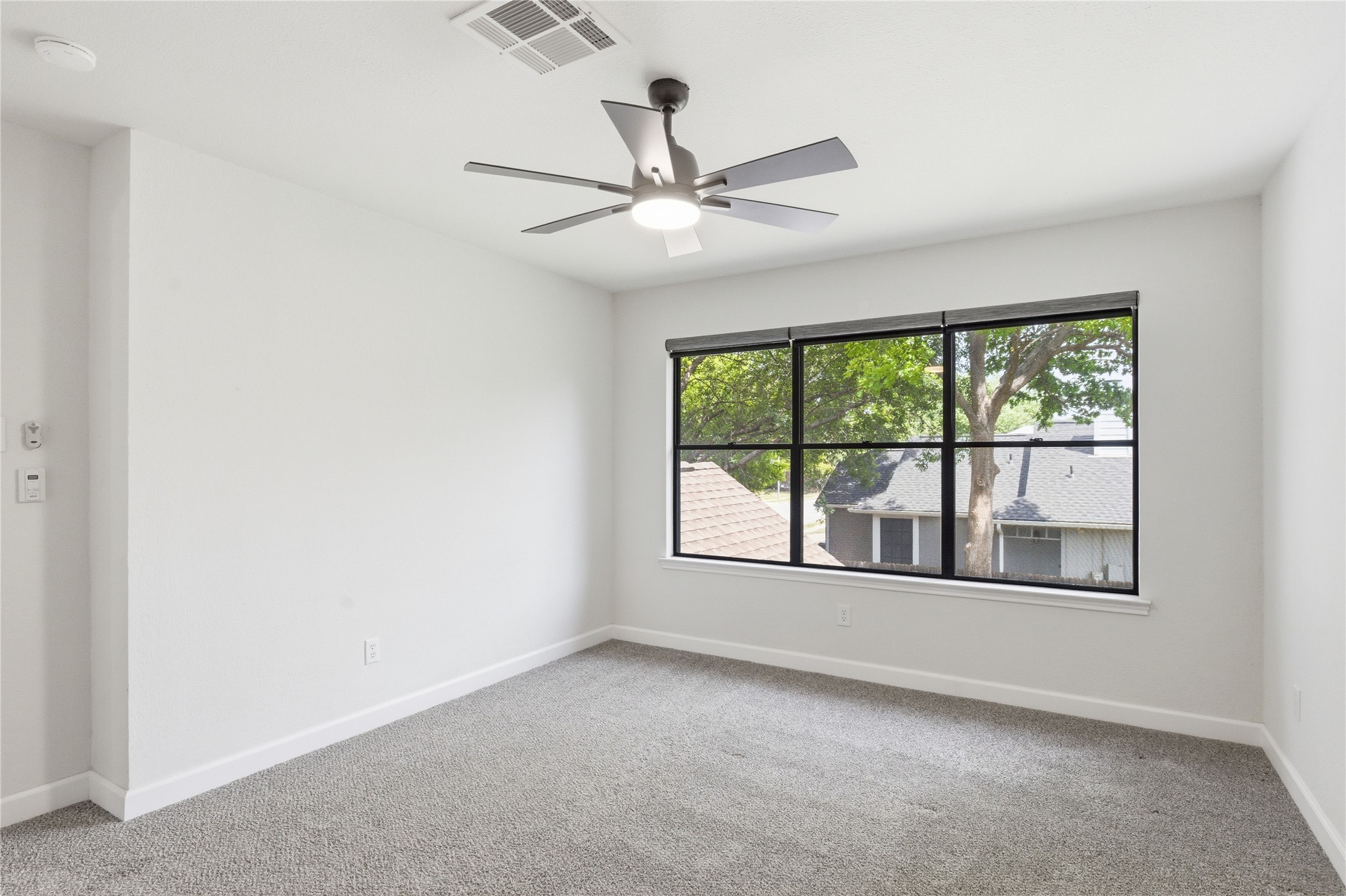 2326 Dowd Lane Austin, TX 78728 - Photo 22 of 30 an empty room with a ceiling fan and a large window