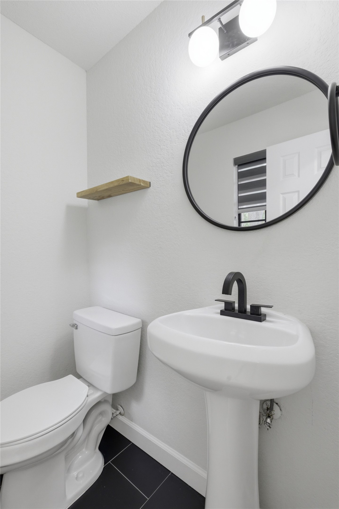 2326 Dowd Lane Austin, TX 78728 - Photo 24 of 30 a bathroom with a sink a toilet and mirror