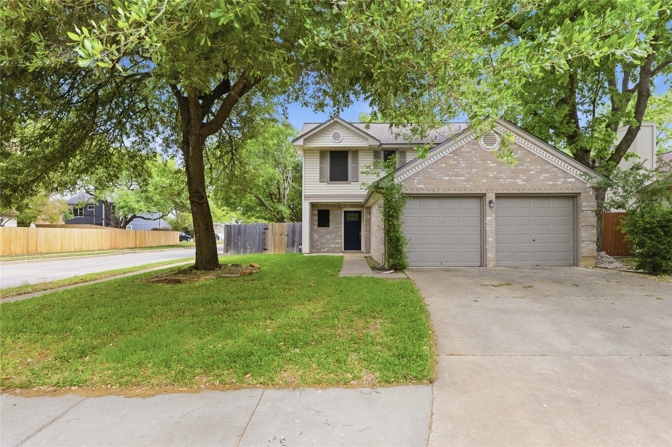 2326 Dowd Lane Austin, TX 78728 - Photo 26 of 30 a front view of a house with a garden and trees