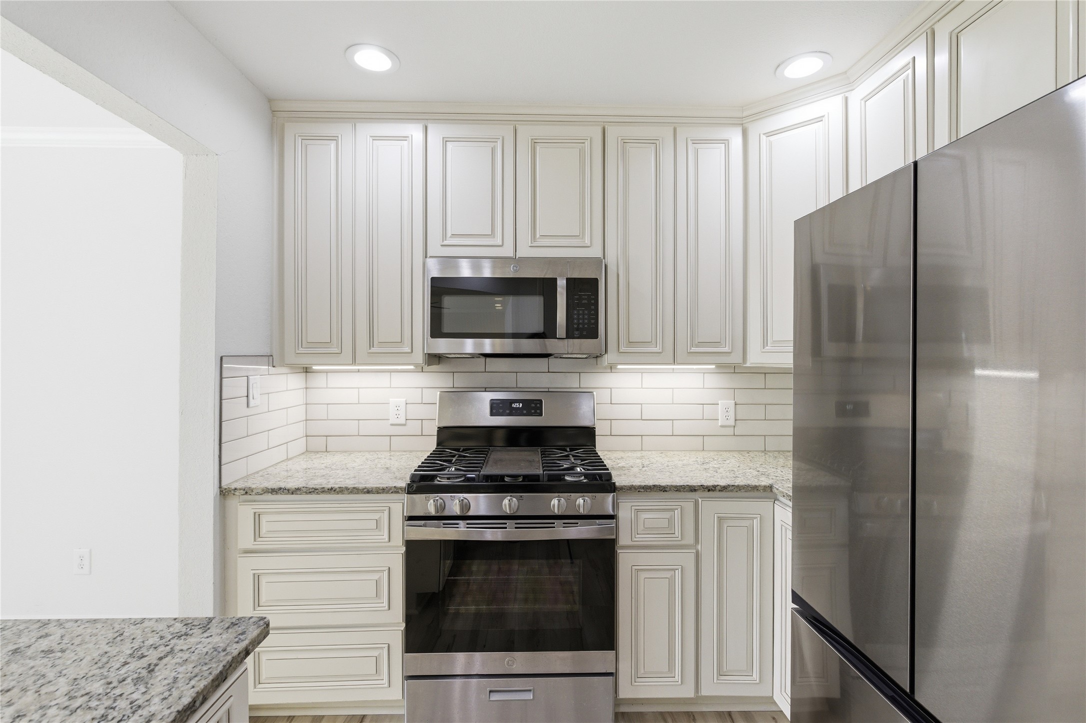 2326 Dowd Lane Austin, TX 78728 - Photo 6 of 30 a kitchen with a refrigerator stove and cabinets