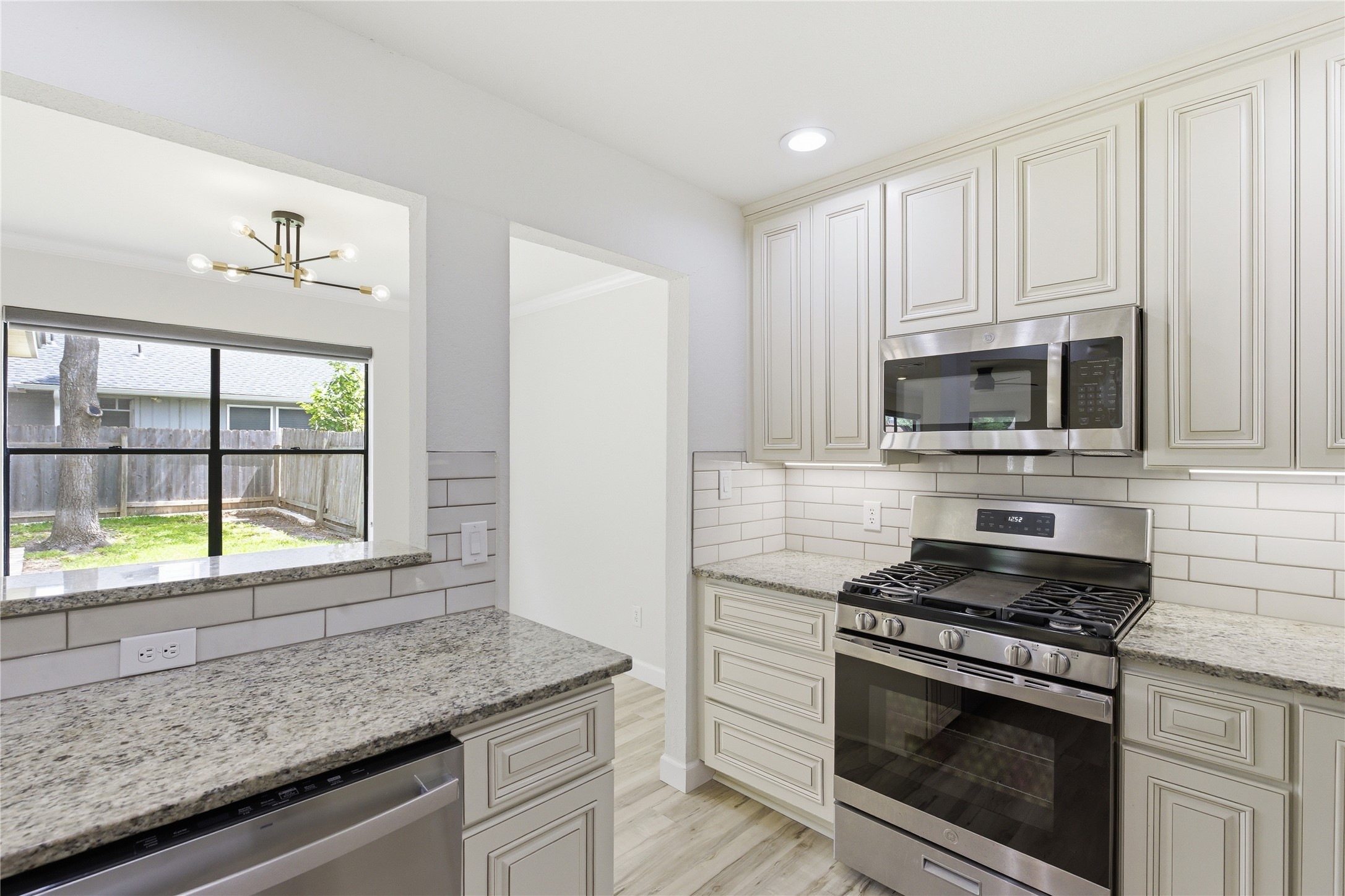 2326 Dowd Lane Austin, TX 78728 - Photo 7 of 30 a kitchen with stainless steel appliances granite countertop a stove a microwave and a sink