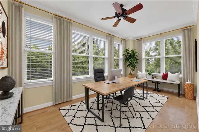 a view of a workspace with furniture and a window