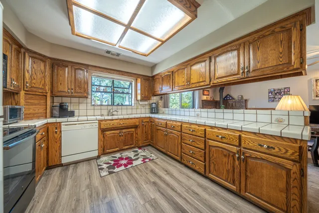 a kitchen with sink cabinets and window