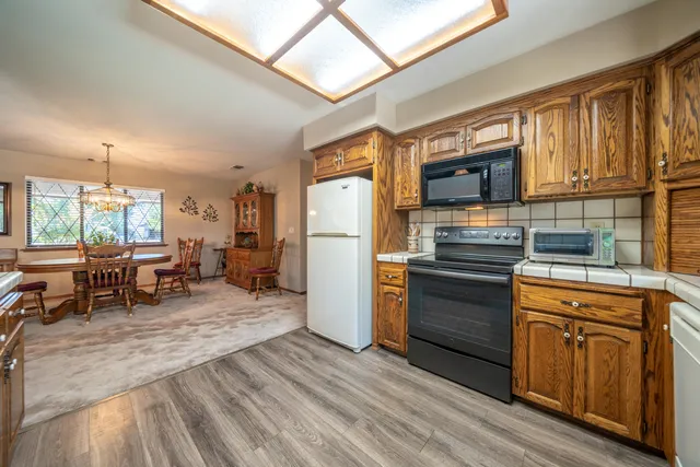 a kitchen with stainless steel appliances granite countertop a refrigerator stove microwave and sink