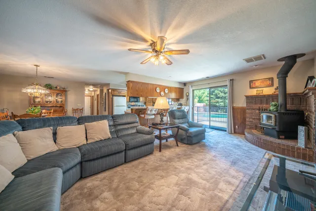 a living room with fireplace furniture and a flat screen tv
