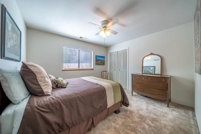 a bedroom with a bed and a dresser