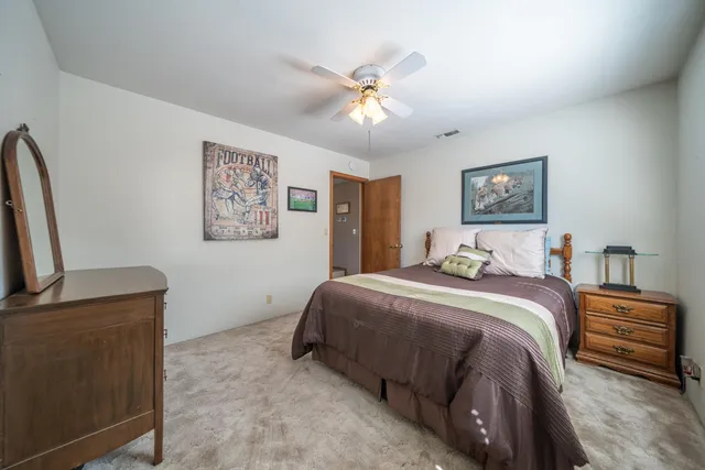 a bed room with a bed and a flat screen tv
