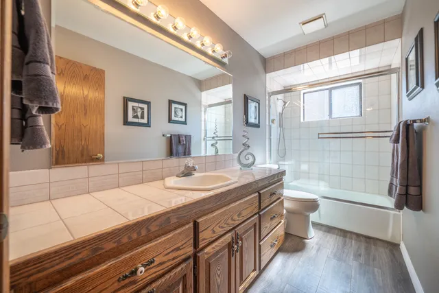a spacious bathroom with a double vanity sink and a mirror