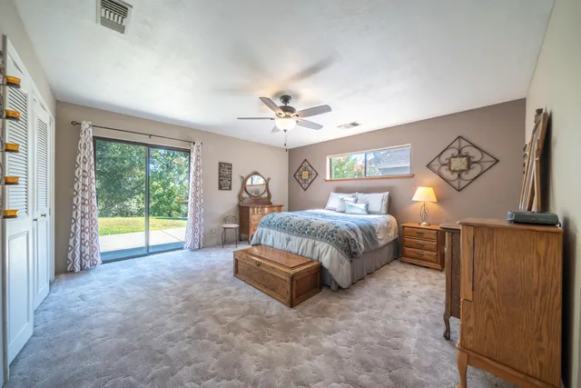 a spacious bedroom with a bed and a large window