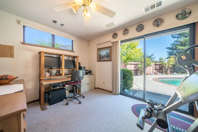 a view of a workspace with furniture and a window