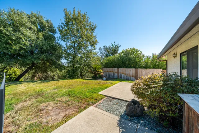 a house view with swimming pool in front of it
