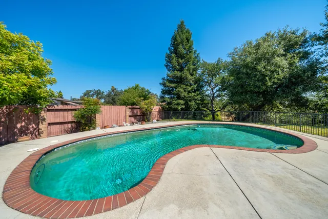 a view of a swimming pool with a patio
