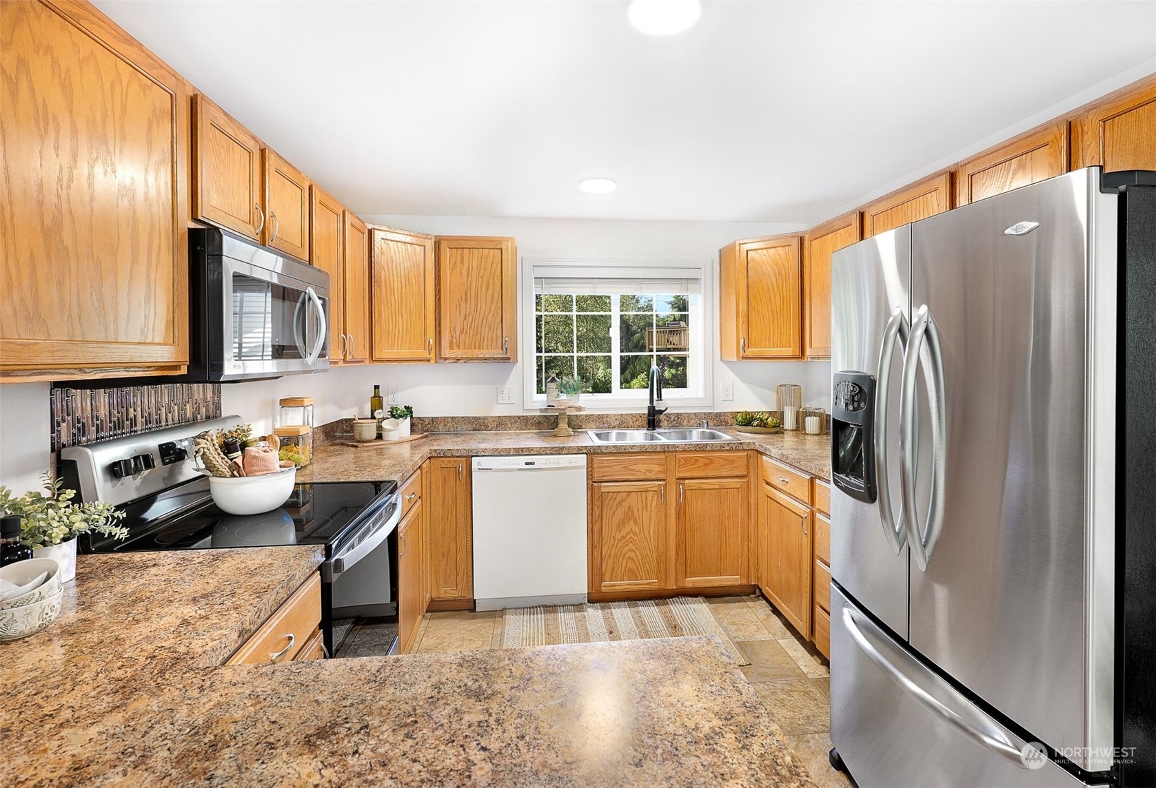 17905 Circle Drive Bothell, WA 98011 - Photo 26 of 39 a kitchen with stainless steel appliances granite countertop a refrigerator stove and sink