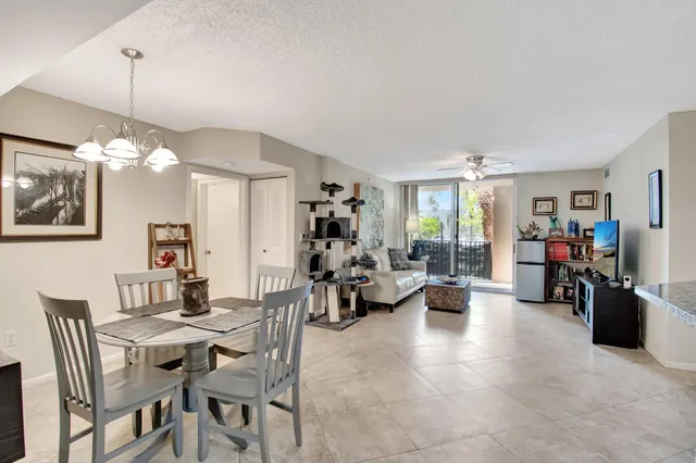 a view of a dining room with furniture and a chandelier