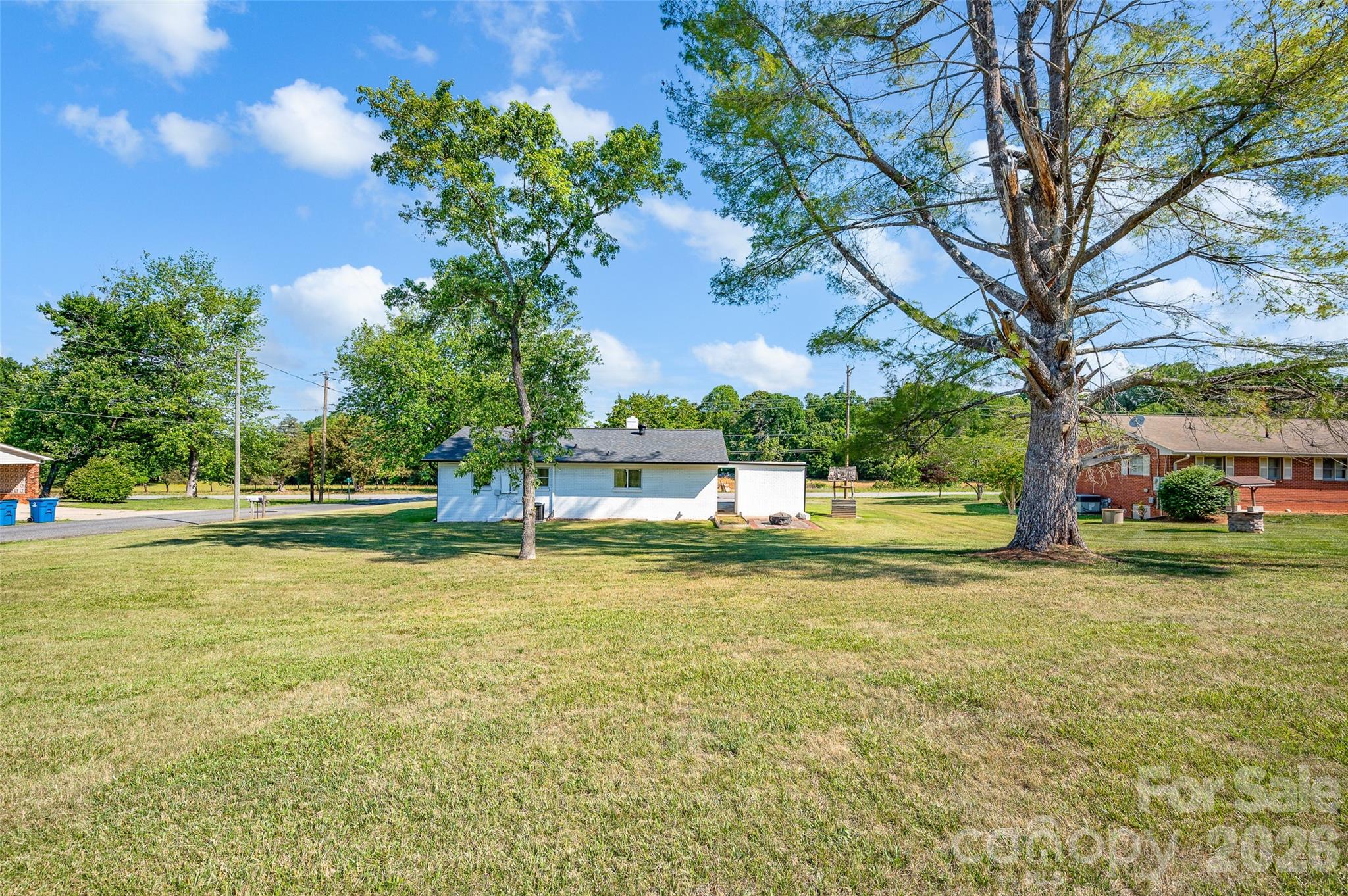 3033 West Highway 10 Conover, NC 28613 - Photo 7 of 26 a view of a fountain in front of a house with a big yard