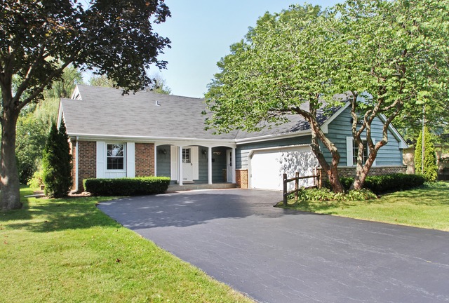 1728 Riverside Court Glenview, IL 60025 - Photo 1 of 18 a front view of a house with a garden and trees