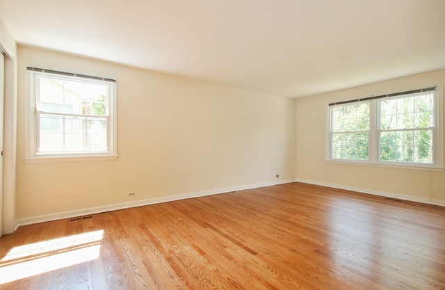 1728 Riverside Court Glenview, IL 60025 - Photo 12 of 18 an empty room with wooden floor and windows