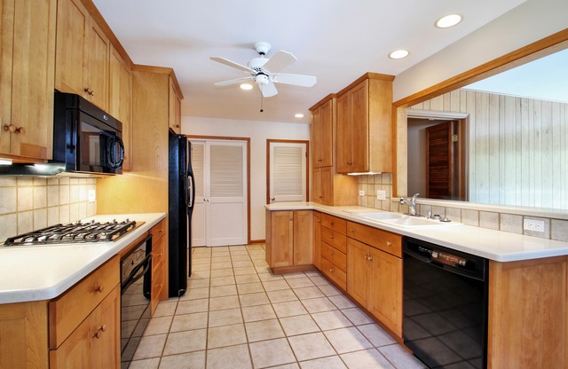 1728 Riverside Court Glenview, IL 60025 - Photo 5 of 18 a kitchen with stainless steel appliances a sink stove and refrigerator