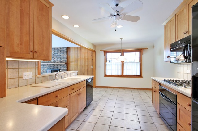 1728 Riverside Court Glenview, IL 60025 - Photo 6 of 18 a kitchen with a sink stove and cabinets