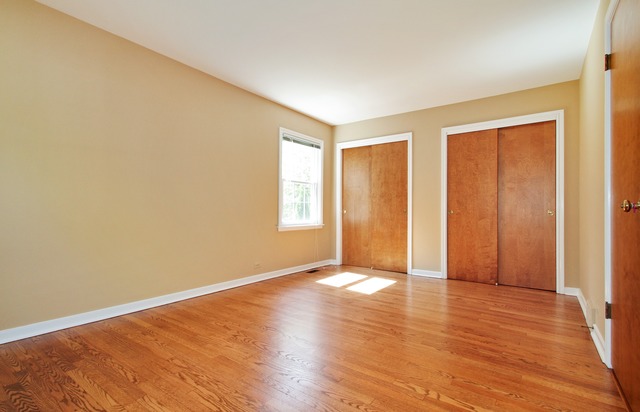 1728 Riverside Court Glenview, IL 60025 - Photo 8 of 18 a view of an empty room with wooden floor and a window