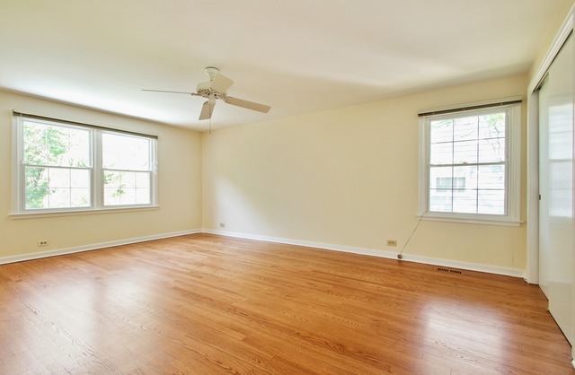 1728 Riverside Court Glenview, IL 60025 - Photo 10 of 18 an empty room with wooden floor and windows
