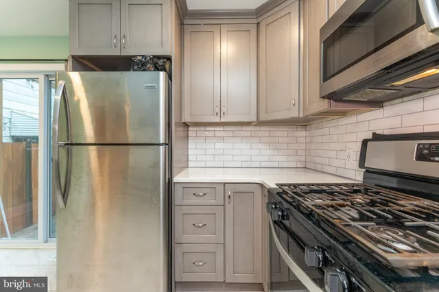 a kitchen with appliances and cabinets
