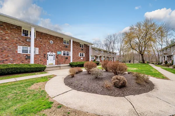 a view of a house with backyard and sitting area