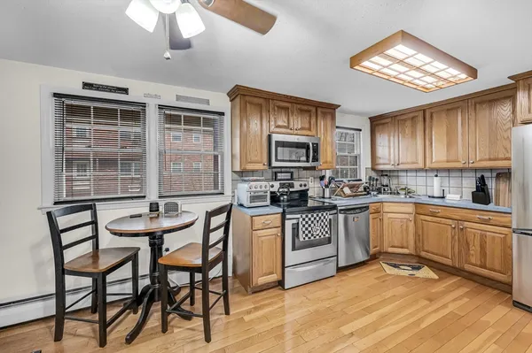 a kitchen with cabinets a sink and appliances