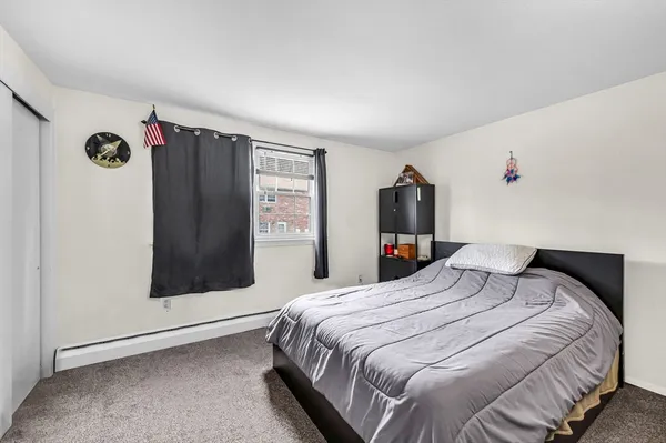 a bedroom with a large bed and a window