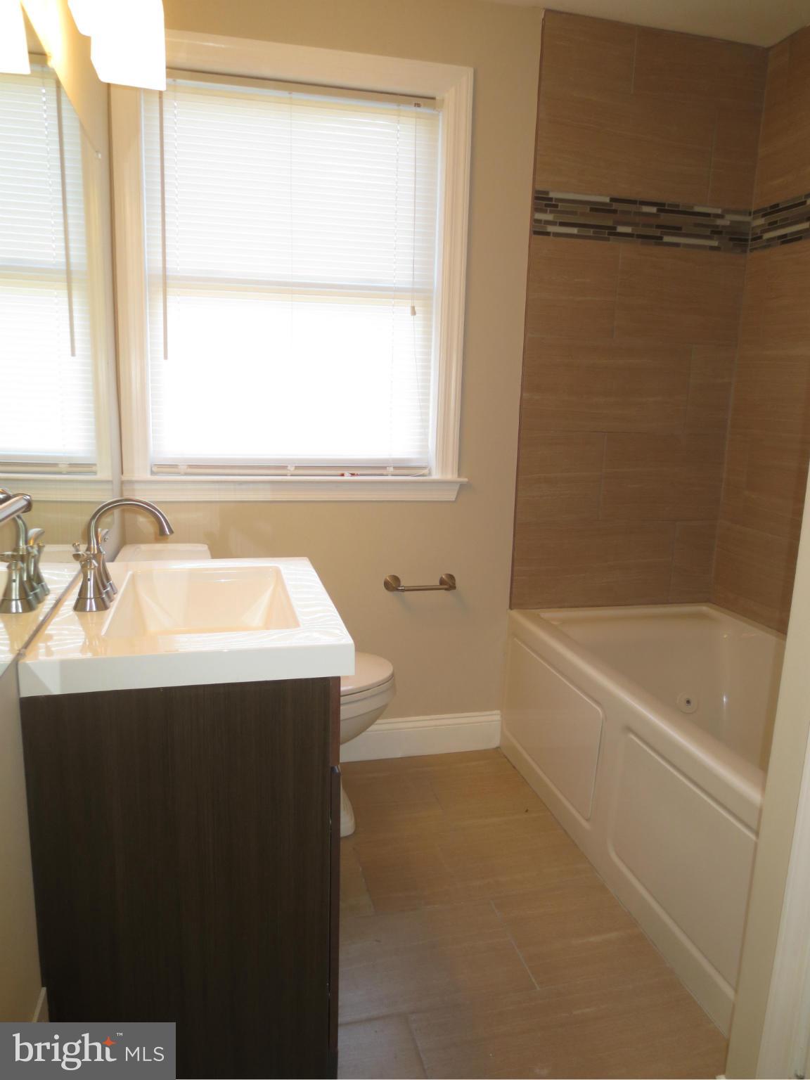 1801 Heathfield Road Baltimore, MD 21239 - Photo 11 of 28 a bathroom with a sink and a bathtub