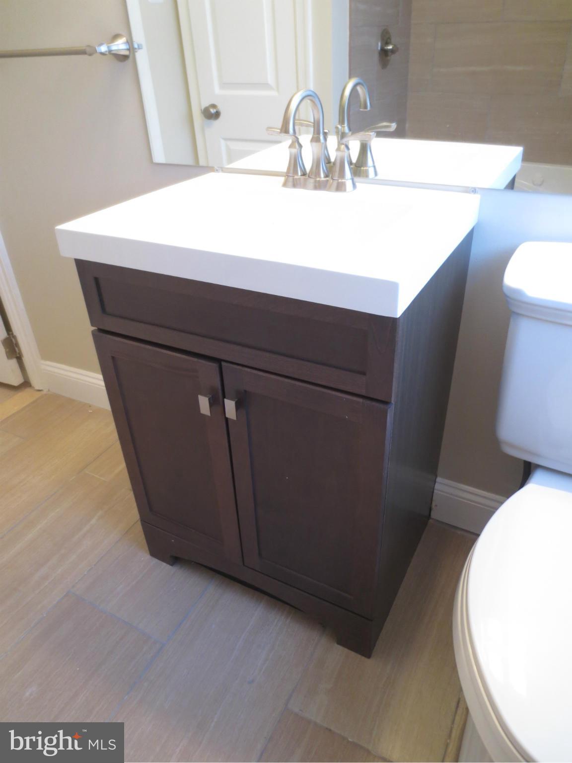 1801 Heathfield Road Baltimore, MD 21239 - Photo 14 of 28 a bathroom with a sink and a mirror