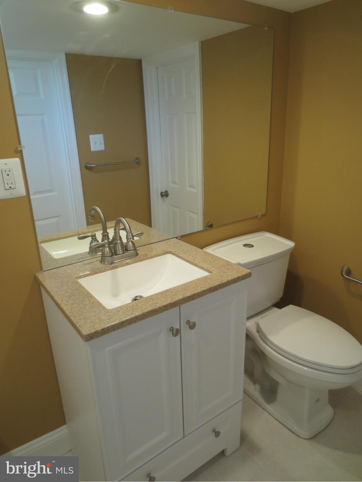1801 Heathfield Road Baltimore, MD 21239 - Photo 20 of 28 a bathroom with a sink toilet and vanity
