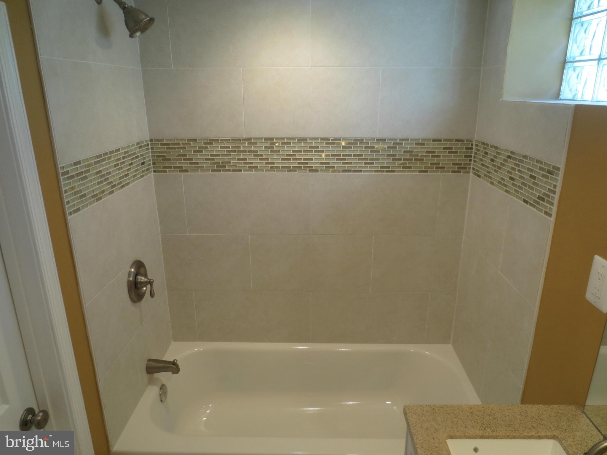 1801 Heathfield Road Baltimore, MD 21239 - Photo 21 of 28 a bathroom with a shower and a toilet