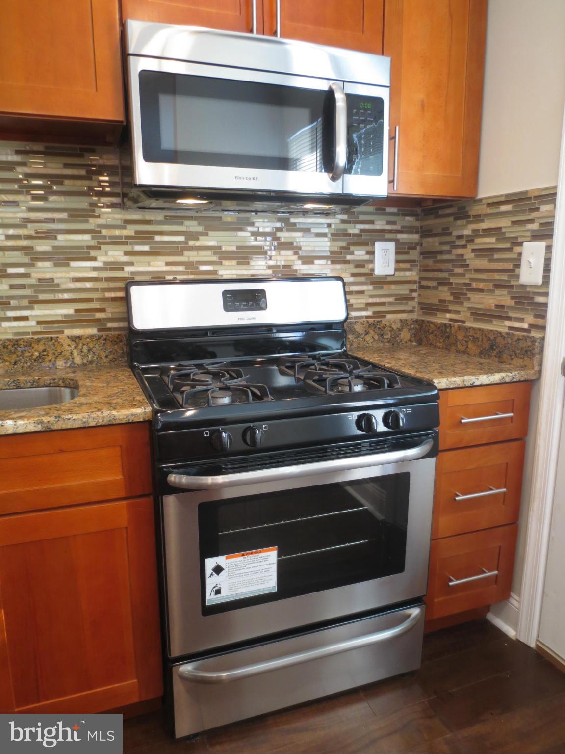 1801 Heathfield Road Baltimore, MD 21239 - Photo 25 of 28 a stove top oven sitting inside of a kitchen
