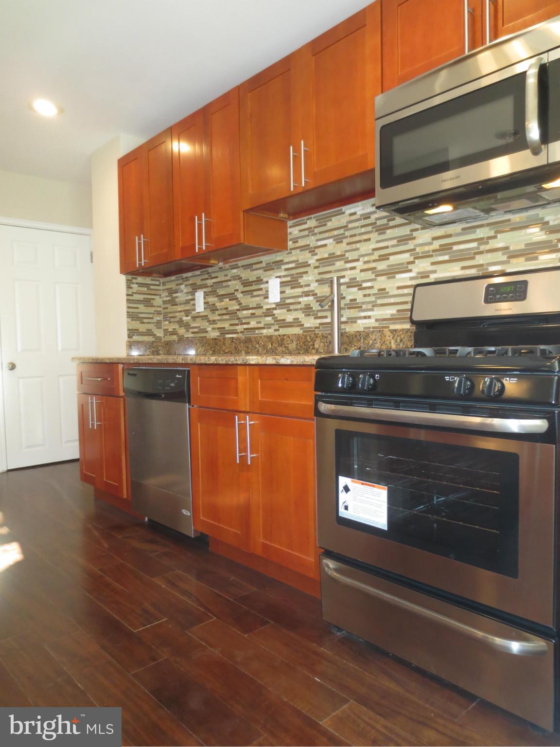 1801 Heathfield Road Baltimore, MD 21239 - Photo 4 of 28 a stove top oven sitting inside of a kitchen