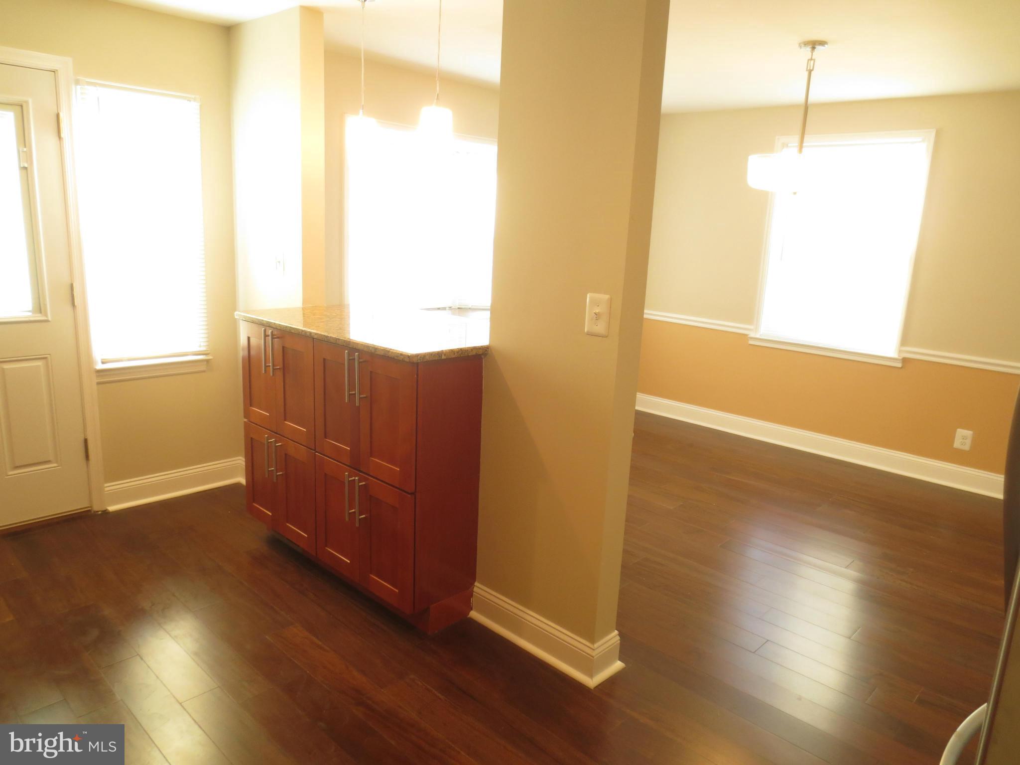 1801 Heathfield Road Baltimore, MD 21239 - Photo 7 of 28 a view of an empty room with wooden floor and a window