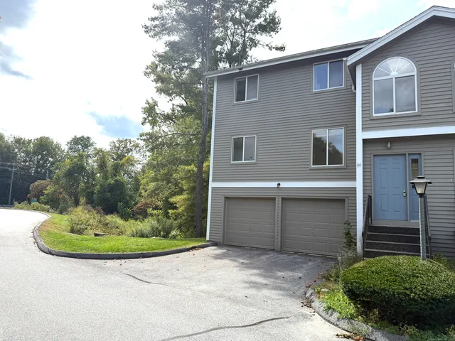 a front view of a house with a yard garage and outdoor seating