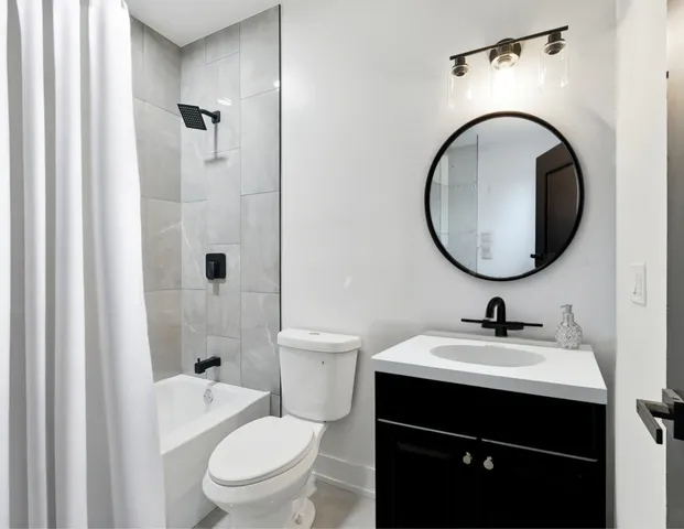 a bathroom with a sink a toilet and a mirror