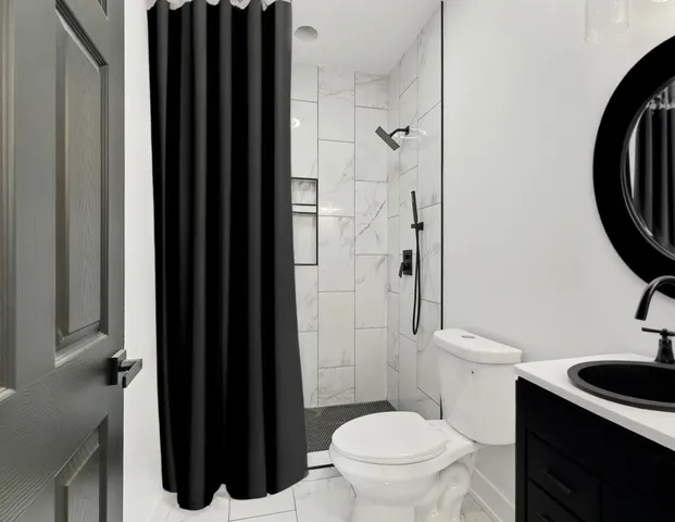 a bathroom with a toilet a sink and a shower