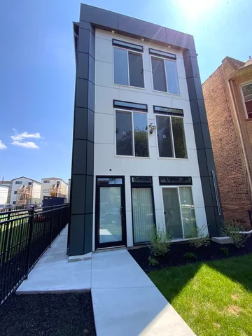 a view of a brick house with many windows